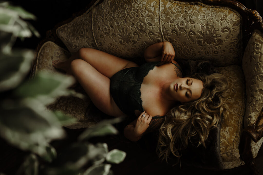 black lace on a blonde boudoir client laying down on a gold couch
